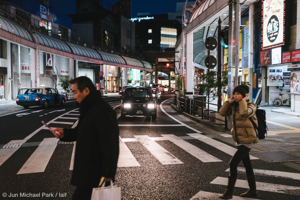 KAGOSHIMA, JAPAN - February 3, 2016: Locals cross a crosswalk in Tenmonkan, a bustling shopping and entertainment district in Kagoshima.