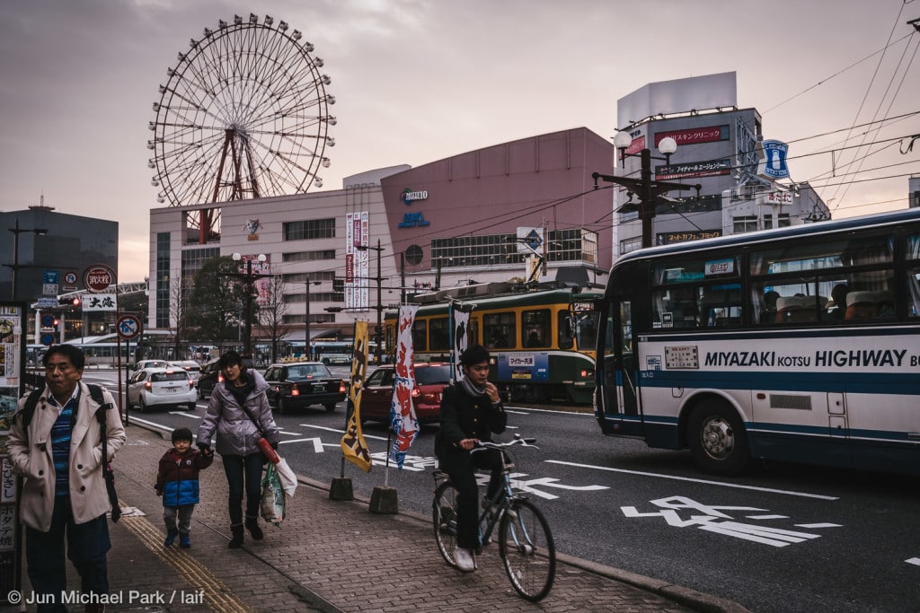 KAGOSHIMA, JAPAN - February 4, 2016: Locals pass by the Kagoshima Chu-o station and Amu Plaza shopping mall around sunset.
