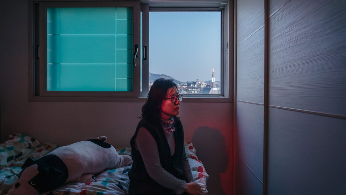 North Korean defector Kim Ryon-hui is directed to look to the right of the frame by Seoul photographer Jun Michael Park in a portrait setting at her home in Seoul.