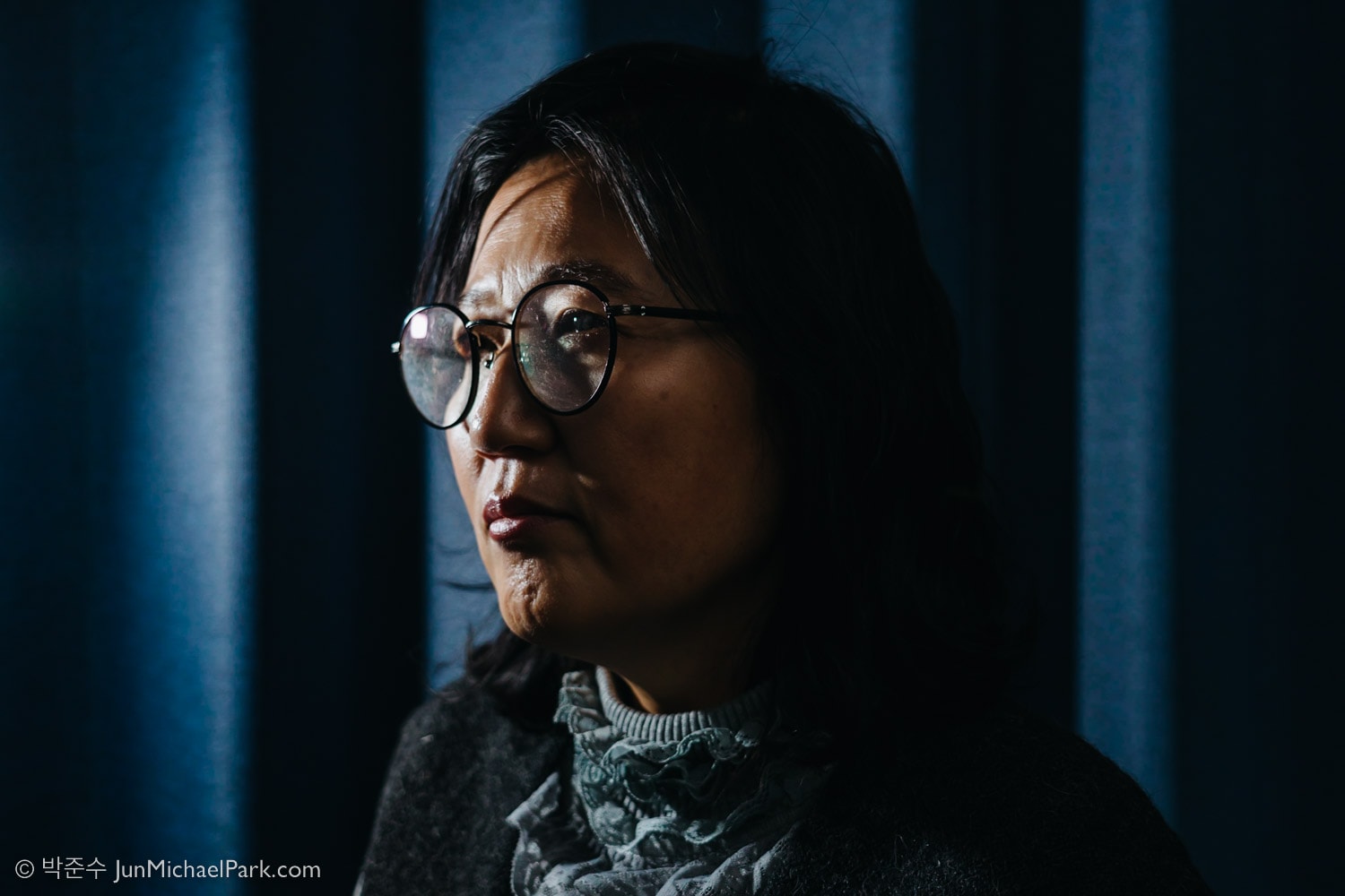 North Korean defector Kim Ryon-hui is directed to look to the left of the frame by Seoul photographer Jun Michael Park in a portrait setting at her home in Seoul.