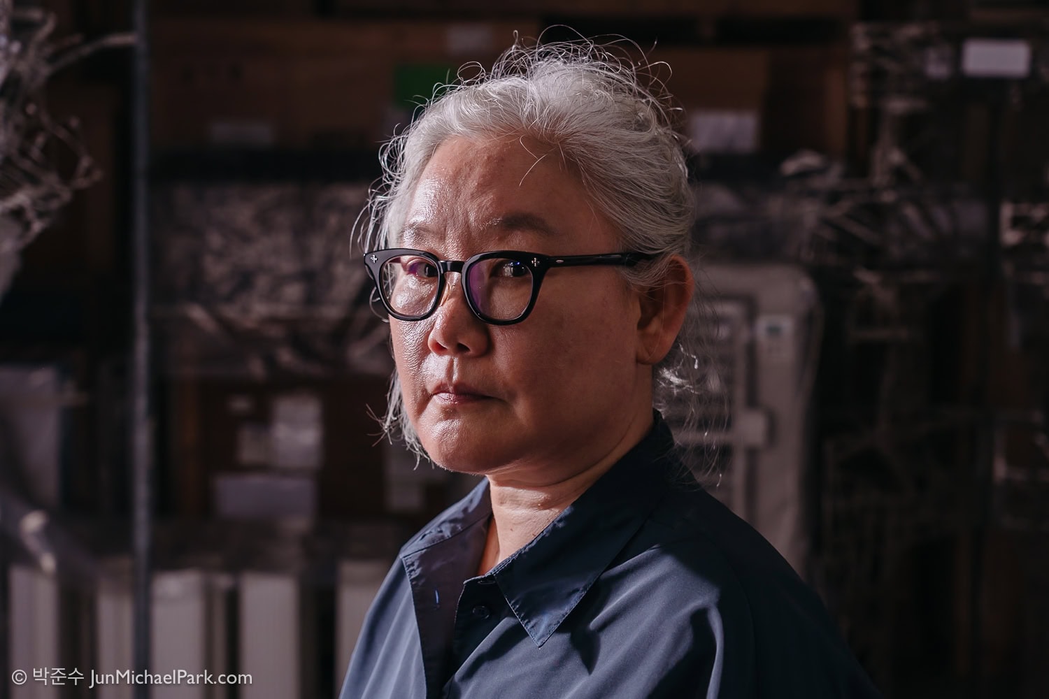 Lee Bul, a celebrated South Korean contemporary artist, looks at the camera at Seoul photographer Jun Michael Park's direction in a portrait setting.